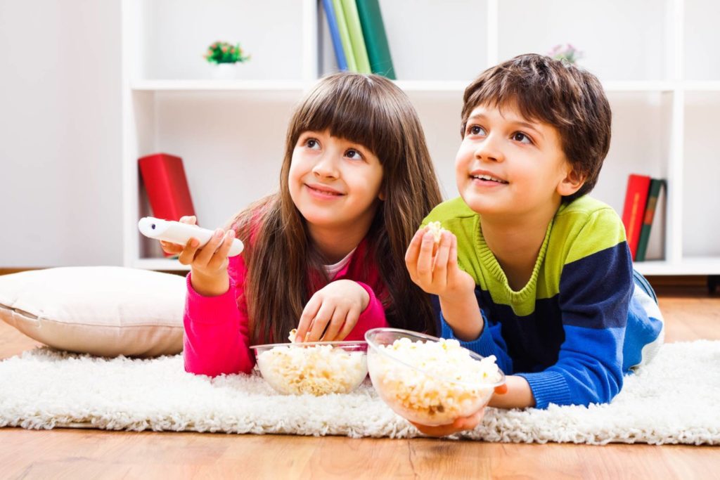 Little,Girl,And,Little,Boy,Enjoy,Eating,Popcorn,And,Watching