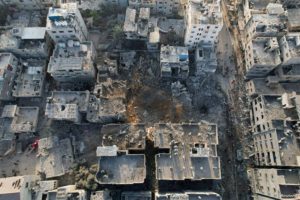 Palestinians gather at the site of Israeli strikes on houses, in Maghazi