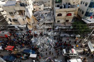 Palestinians gather at the site of an Israeli strike, in Rafah